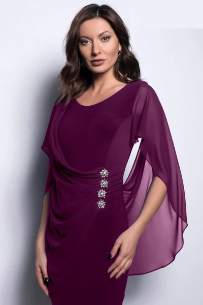 A woman wearing an elegant purple dress with a chiffon shawl and rushing detail on the sides, paired with diamond earrings.