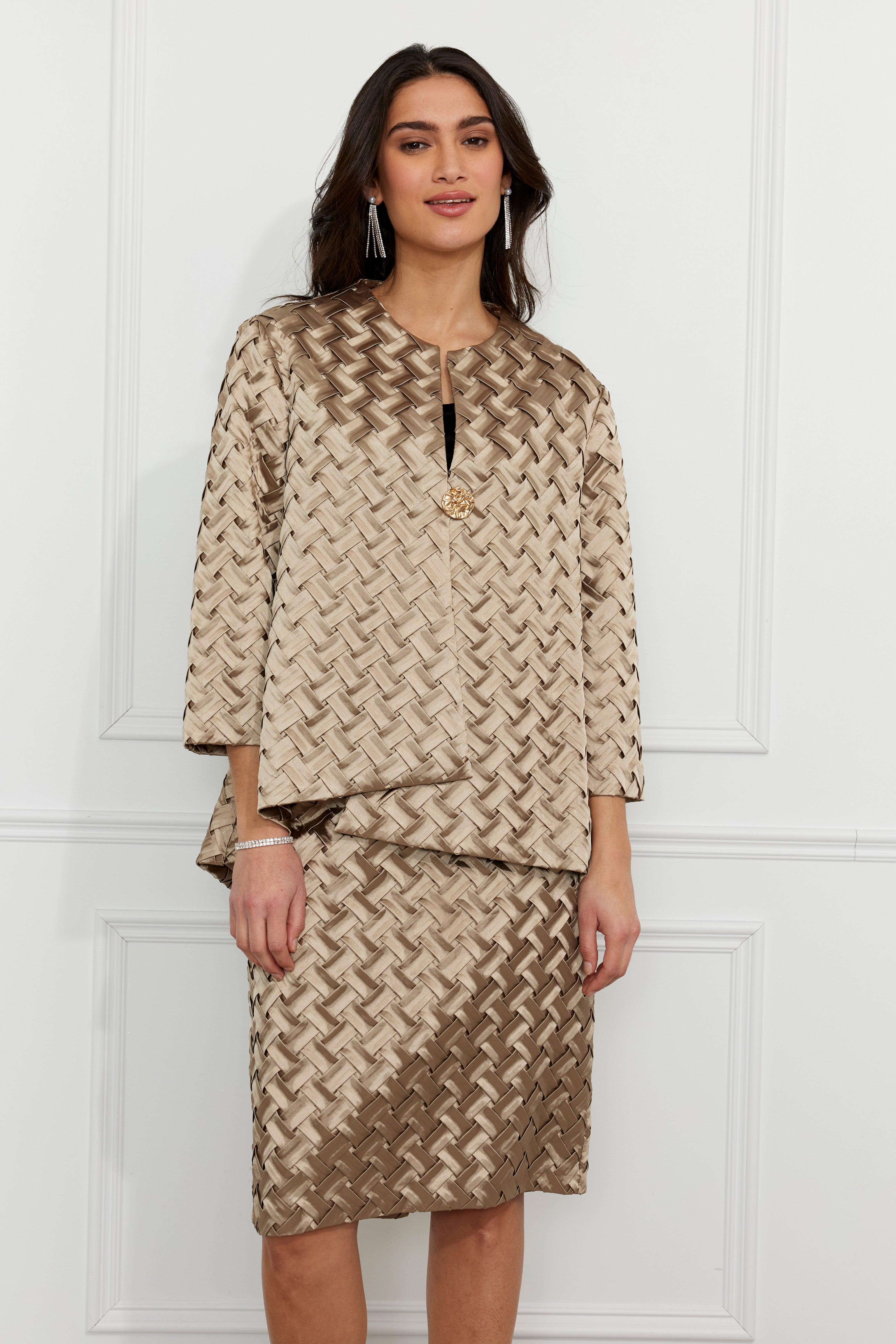 Woman wearing a patterned outfit against a white background