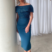 A woman wearing an off-the-shoulder mid-length blue dress with a beaded bodice and a woven satin crepe skirt.