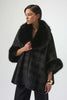 Woman wearing a dark coat with fur trim on a white background