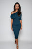 Woman wearing a teal one-shoulder dress against a white background