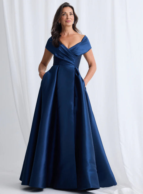 Woman wearing a blue evening gown against a white background
