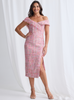 Woman wearing a pink off-shoulder dress with a white background