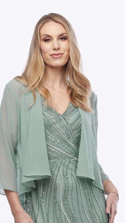 Woman wearing a green dress with a matching shrug on a white background