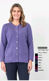 A woman wearing a purple buttoned cardigan with front pockets over a white top, paired with dark pants.
