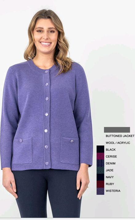 A woman wearing a purple buttoned cardigan with front pockets over a white top, paired with dark pants.