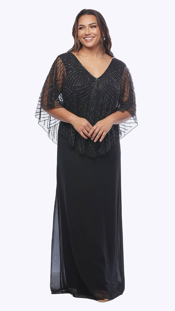 Woman wearing a black evening gown with sheer sleeves on a white background