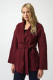 Woman wearing a burgundy coat with a white background