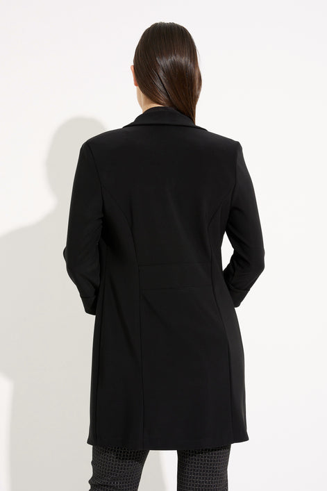 Person wearing a black coat on a white background