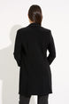Person wearing a black coat on a white background