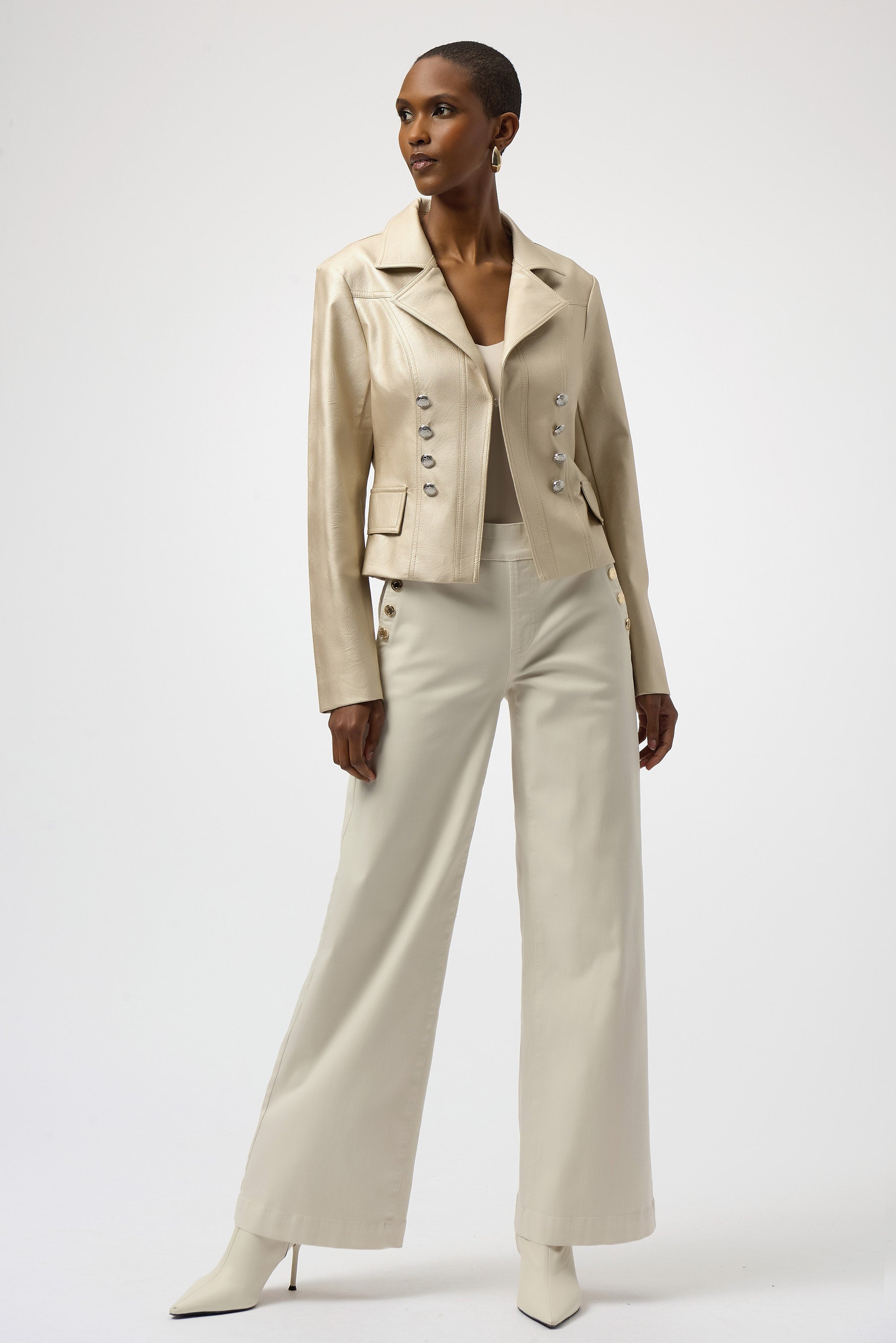Woman wearing a beige suit with wide-leg pants on a white background