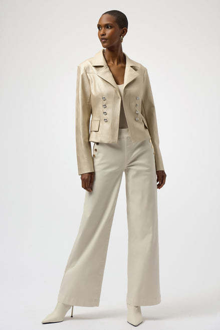 Woman wearing a beige suit with wide-leg pants on a white background