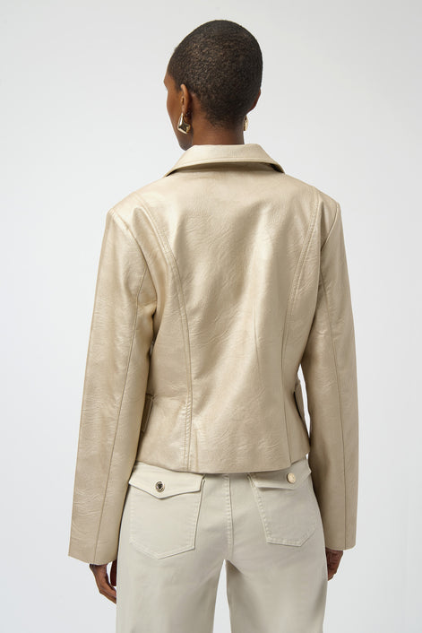 Person wearing a beige leather jacket and pants on a white background