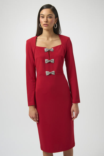 Red dress with silver bow details worn by a model on a white background
