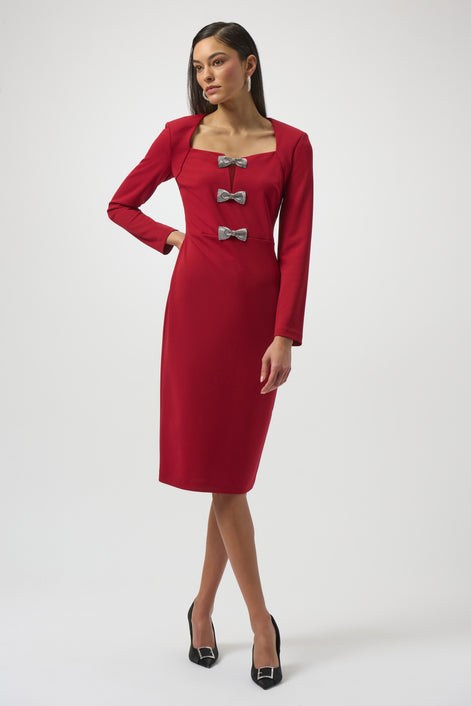 Red dress with silver buttons worn by a model on a white background