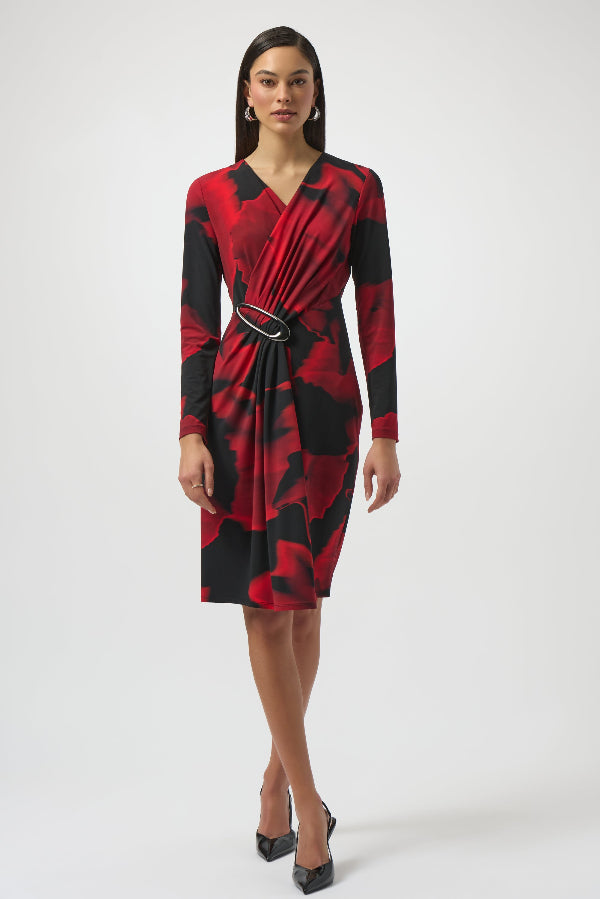 Woman wearing a red and black patterned dress on a white background