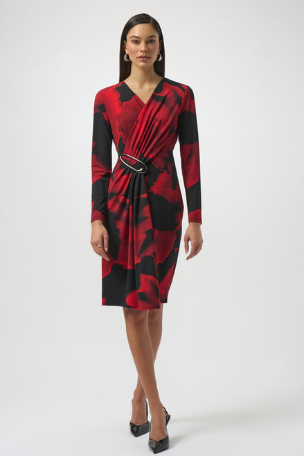 Woman wearing a red and black patterned dress on a white background