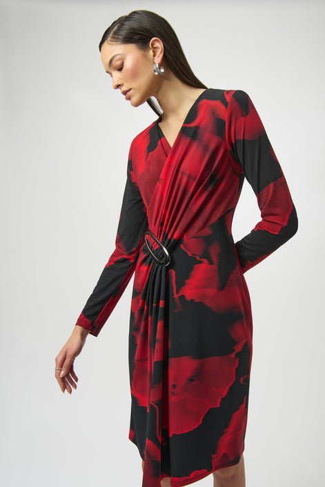 Woman wearing a red and black floral dress on a white background