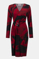 Red and black patterned dress with a belt on a white background