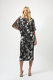 Woman wearing a black floral dress on a white background