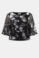 Black floral blouse with sheer sleeves on a white background