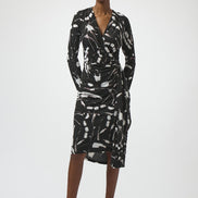 Woman wearing a black and white patterned dress on a white background