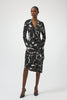 Woman wearing a black and white patterned dress on a white background