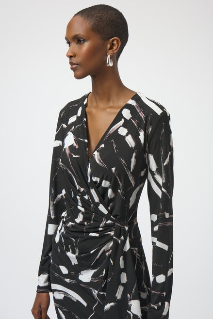 Woman wearing a black and white patterned dress on a plain background