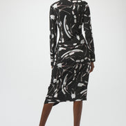 Woman wearing a black and white abstract patterned dress on a white background