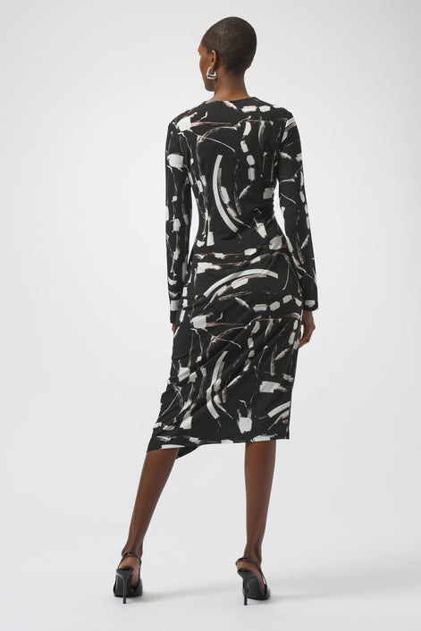 Woman wearing a black and white abstract patterned dress on a white background