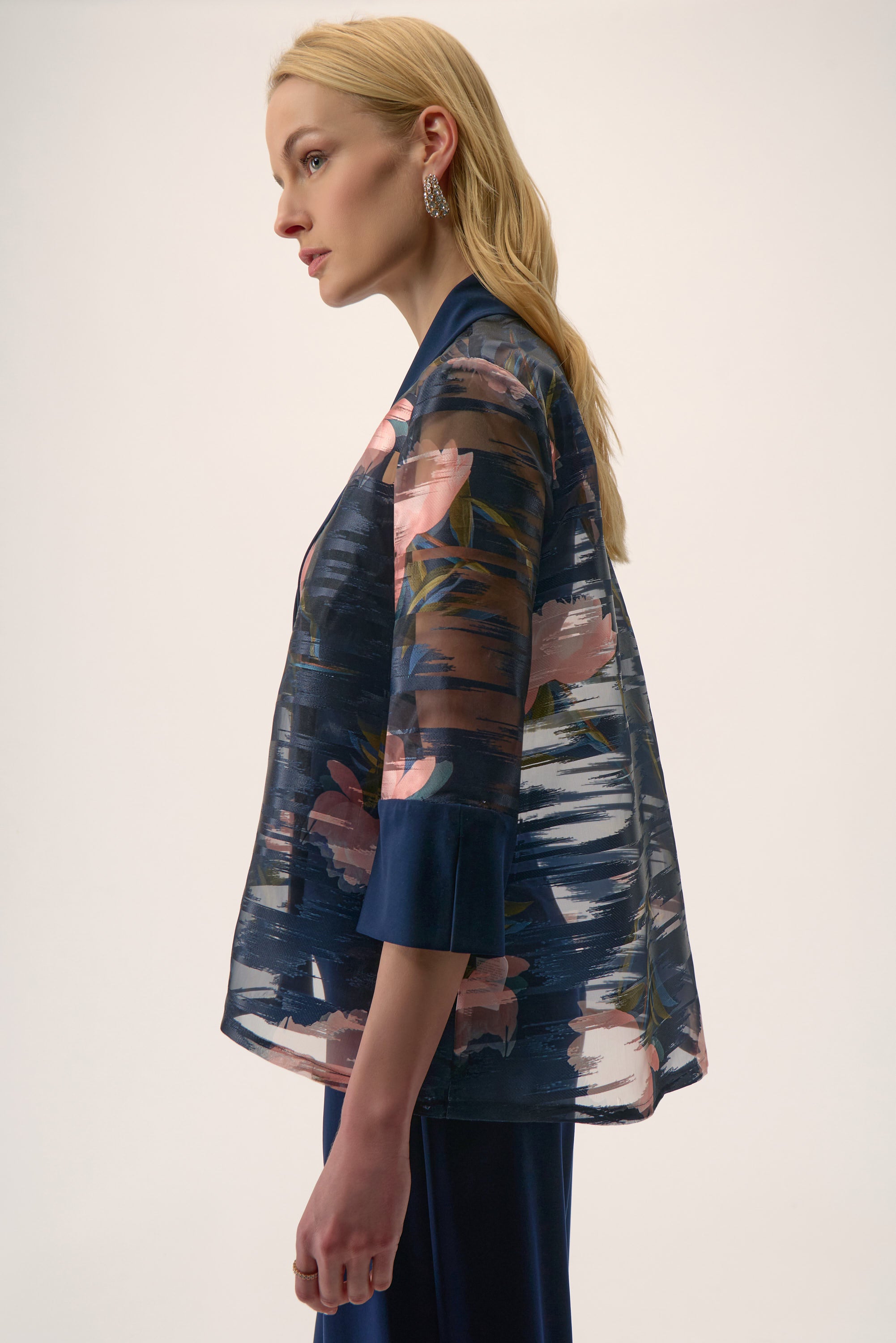 Woman wearing a floral kimono against a white background