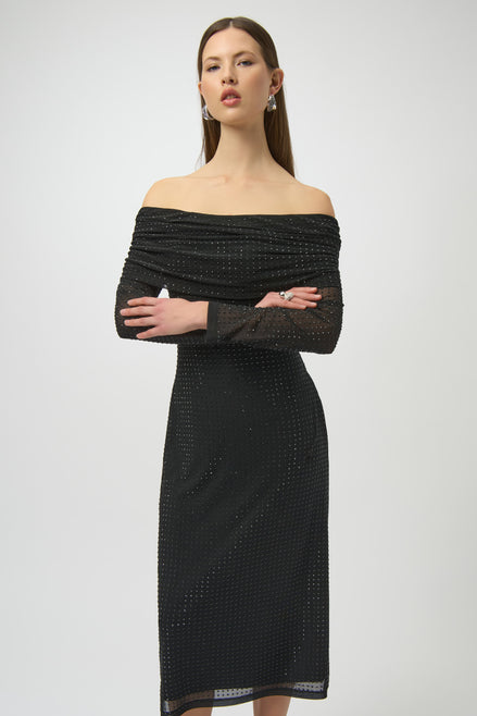 Woman wearing a black off-shoulder dress with a plain background