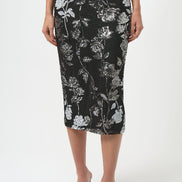 Person wearing a black floral pencil skirt on a white background