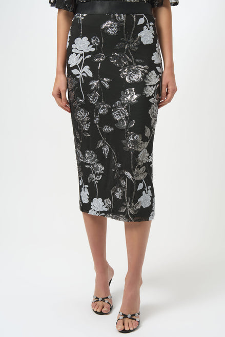 Person wearing a black floral pencil skirt on a white background
