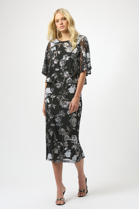Woman wearing a black floral dress on a white background