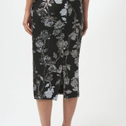 Woman wearing a black floral dress on a white background