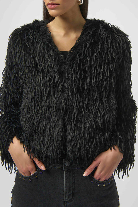 Black furry jacket worn by a model on a white background