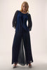 Woman wearing a navy blue outfit with a pleated skirt on a white background