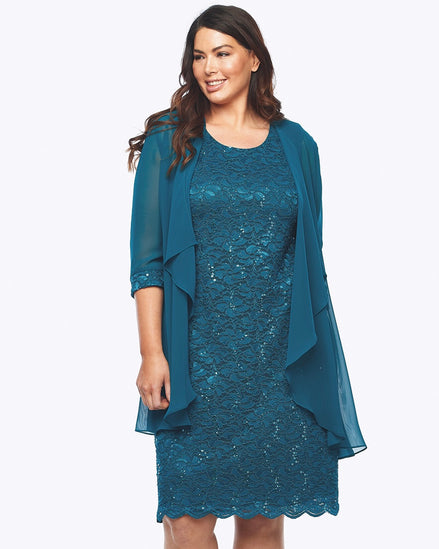 A woman wearing a blue sequined lace stretch-lined dress with a chiffon jacket over it.