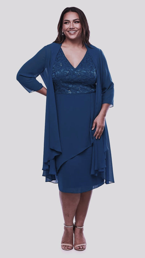A woman wearing a navy blue dress with a sequin lace bodice and a longline jacket.