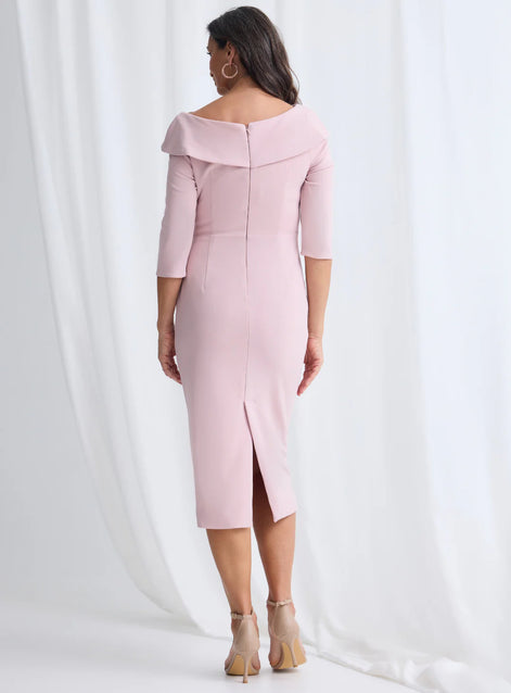 Woman wearing a pink off-shoulder dress with a slit on a white background