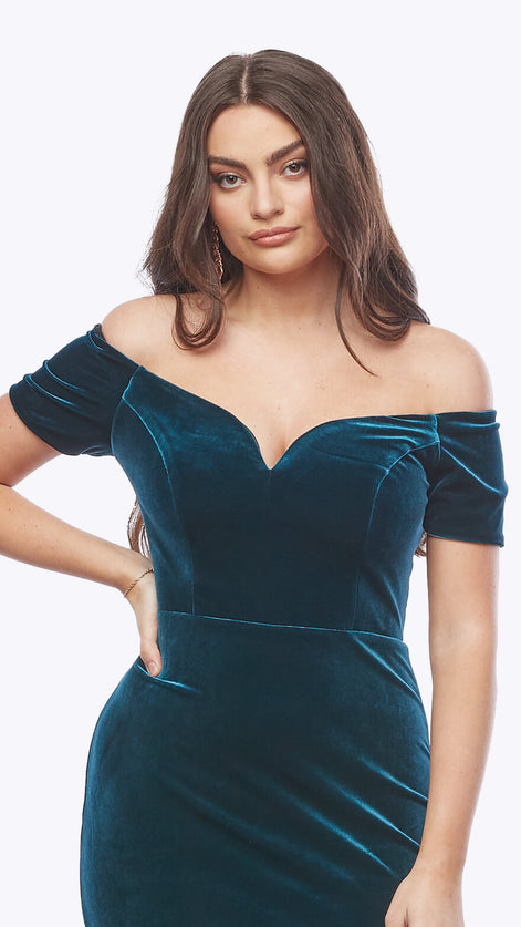 Woman wearing a teal off-shoulder dress on a white background